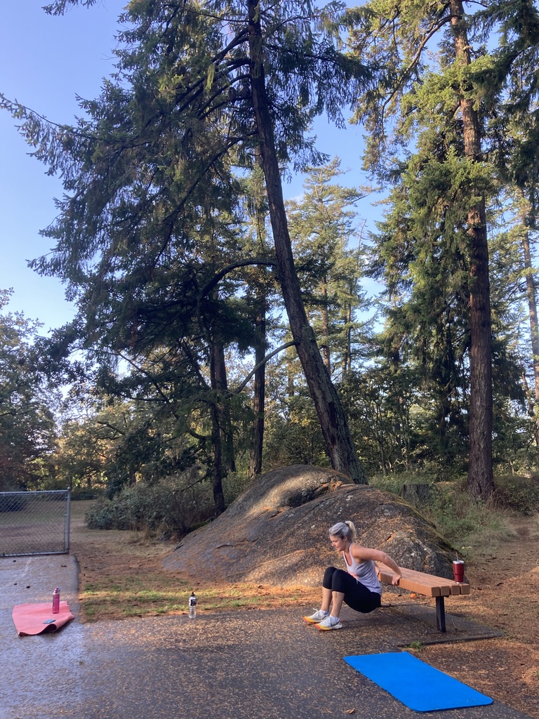 dips on bench at park vertical shot